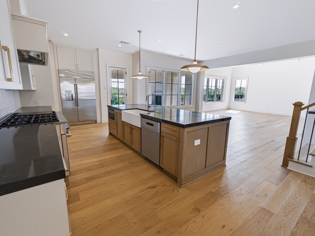 Kitchen with a dark island under a vaulted ceiling, Fort Worth